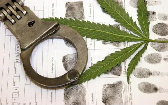 Cannabis leaf with handcuffs symbolizing cannabis laws and legal restrictions in Barcelona Spain 2026
